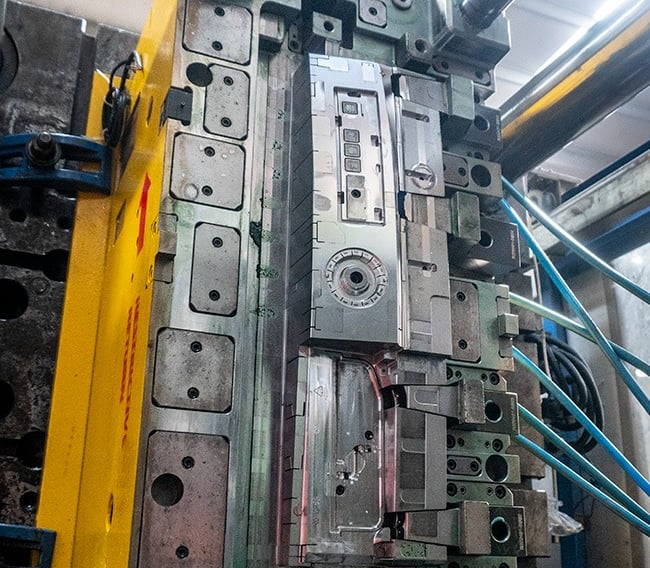 Industrial steel injection mold for plastic manufacturing in a high-precision molding machine.