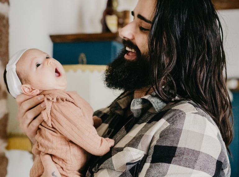 Thomas Bertini laughing while holding his yawning baby daughter — BonjourMrsBride photographer
