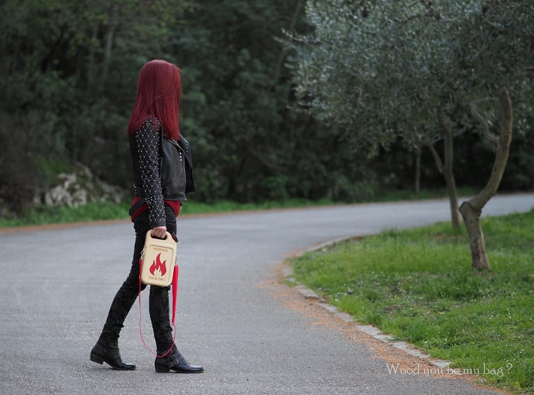 woman holding wooden bag shaped like gas can