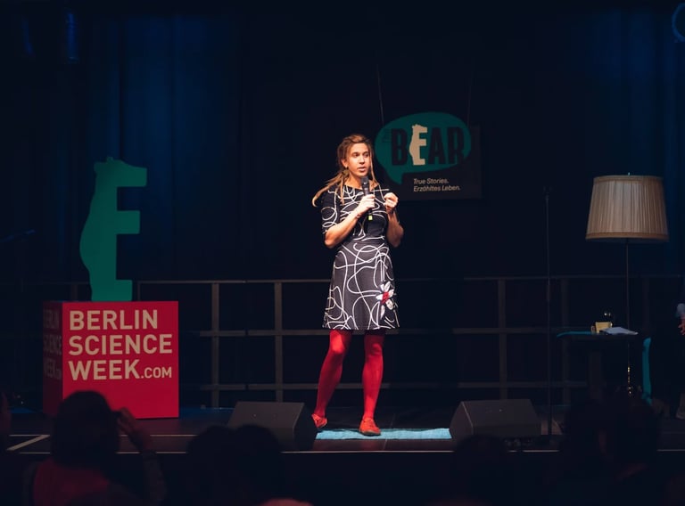 Female scientist on stage telling a story