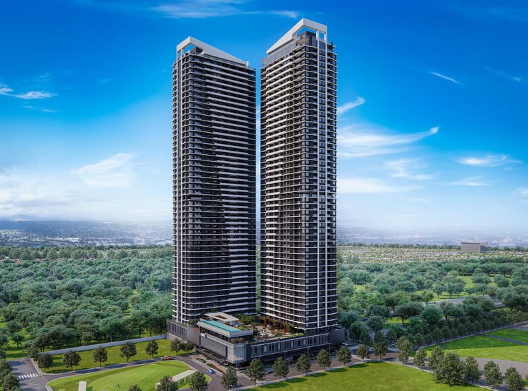Modern twin luxury high-rise residential towers surrounded by lush green urban landscaping and city views.