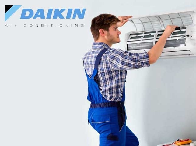 a man and woman standing in front of a wall mounted air conditioner