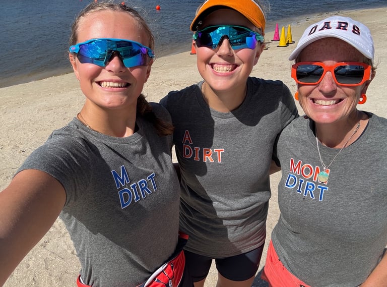 M Dirt, A Dirt and Mom Dirt celebrating at the finish line beach
