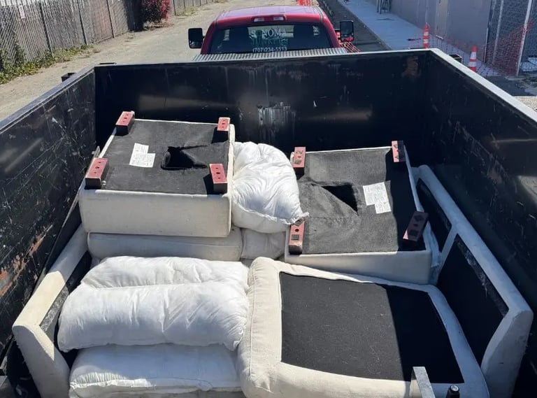 a truck bed with a couch and pillows