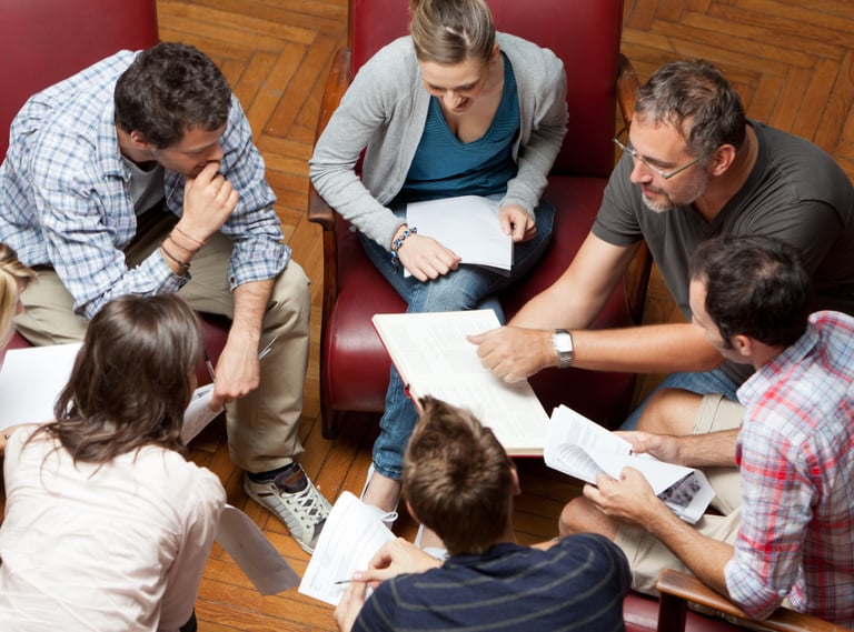 a group of people sitting around a table