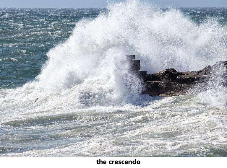 a large wave crashing over a rock formation