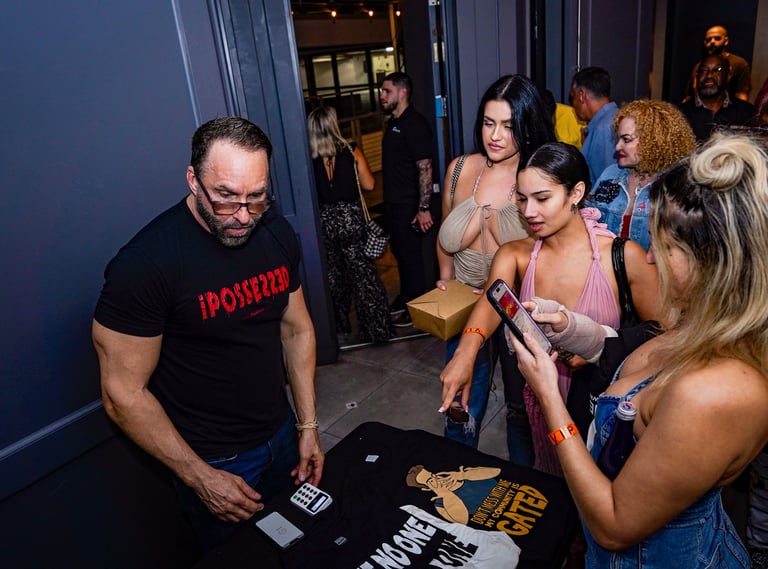 a man and woman standing in front of a table with a sign