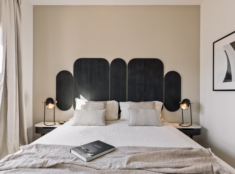 Vibrant bold black wood headboard design in a bedroom with neutral colours and natural materials