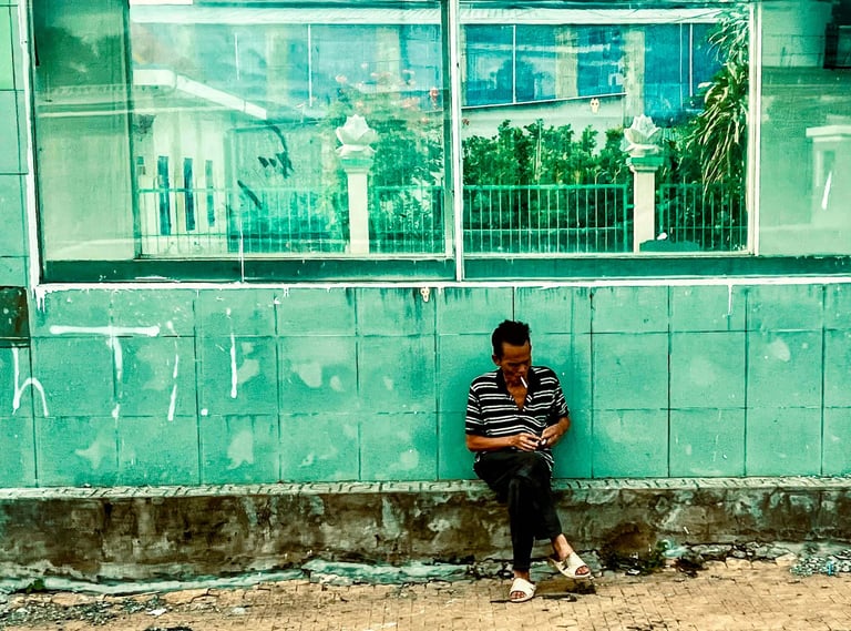 Man Lighting a cigarette in Saigon.