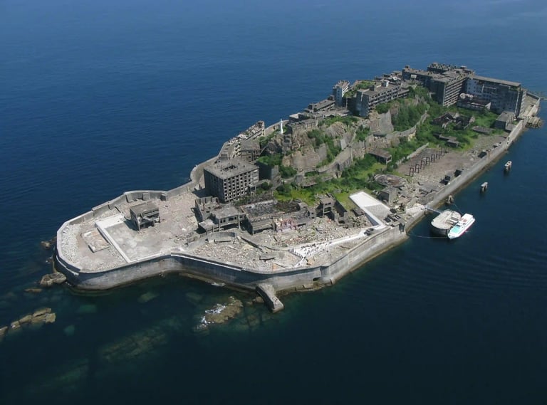 Aerial close-up view of Gunkanjima (Hashima Island), showing dense concrete apartment blocks and aba