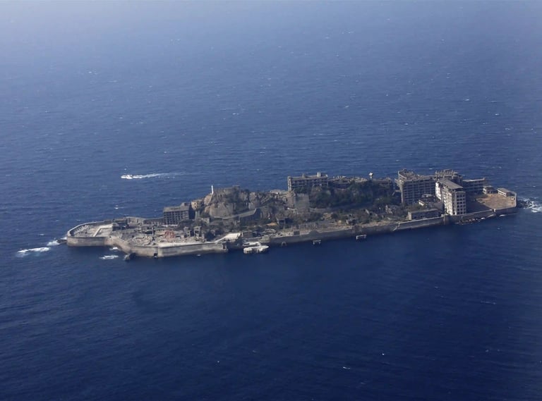 Wide aerial view of Gunkanjima (Hashima Island) off the coast of Nagasaki, revealing its battleship-
