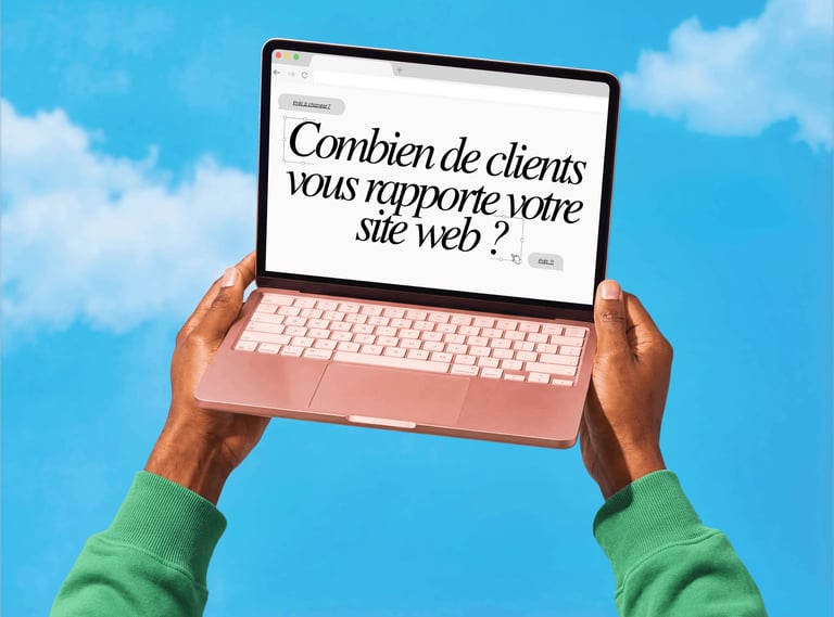 Person holding a pink laptop showing a French business website against a blue sky background.