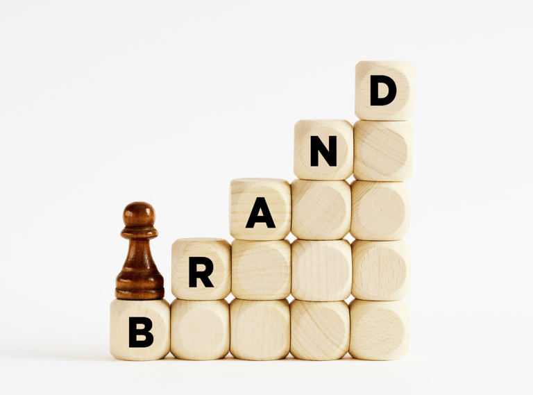 a chess game with a chess piece of wood blocks spelling the word "BRAND"