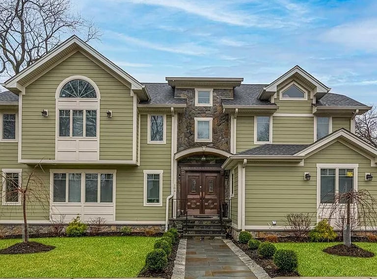 a house with a large front yard and a driveway