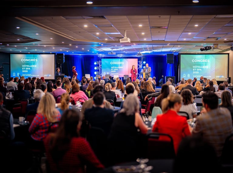 Speakers address a large audience at the Congrès Hôtellerie et Spa 2025 hospitality industry conference.