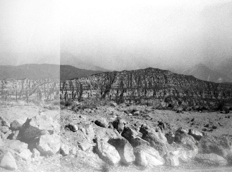 a black and white photo of a mountain scene