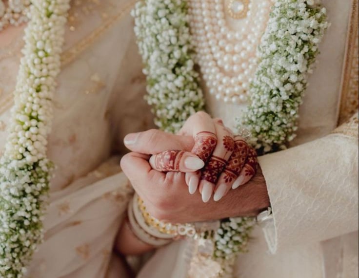 a bride and groom holding hands