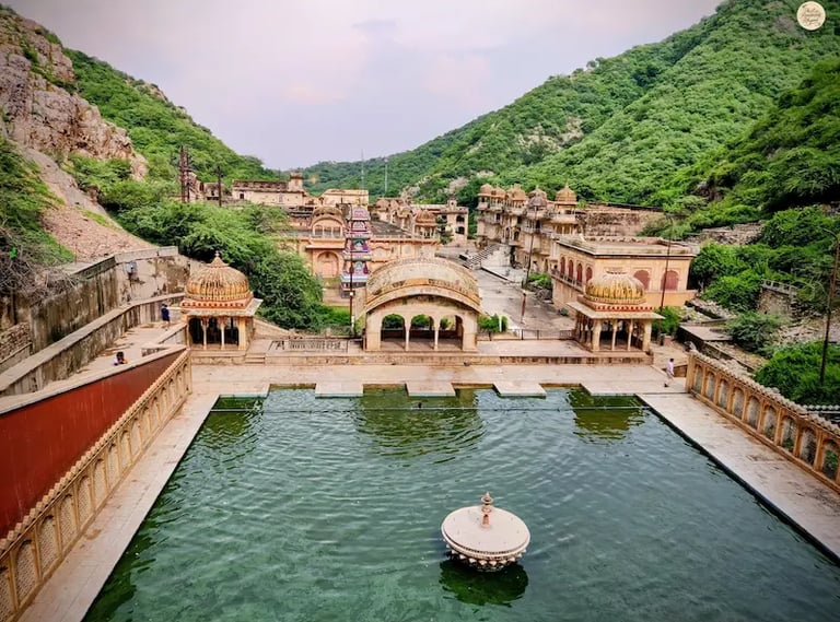 Enjoy a panoramic hilltop view of Galta Ji Temple complex in Jaipur, an ancient temple site surrounded by Aravalli hills.