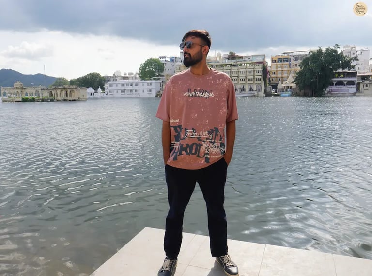 Serene lakeside scene with cloudy skies at Gangaur Ghat Udaipur Rajasthan India.