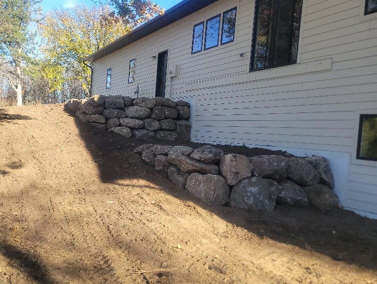 boulder wall behind home