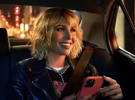 a woman in a leather jacket and a cell phone