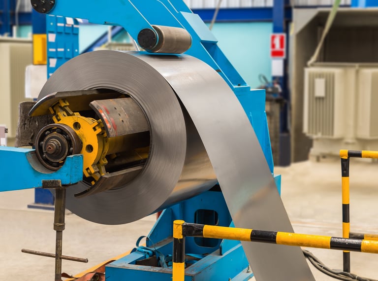 Steel coils passing through the decoiler