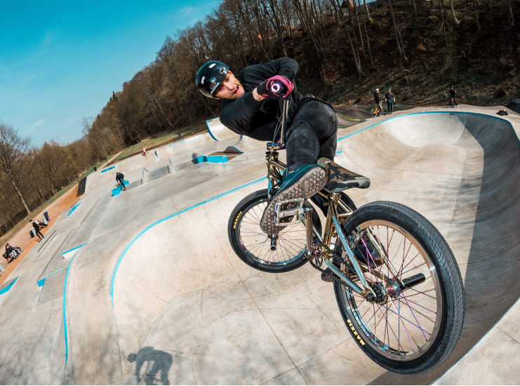 a man riding a bike on a ramp in a skate park