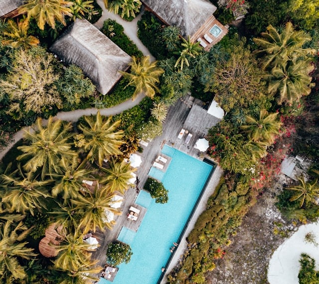 an aerial view of a resort pool at an integrated wellness hotel and spa