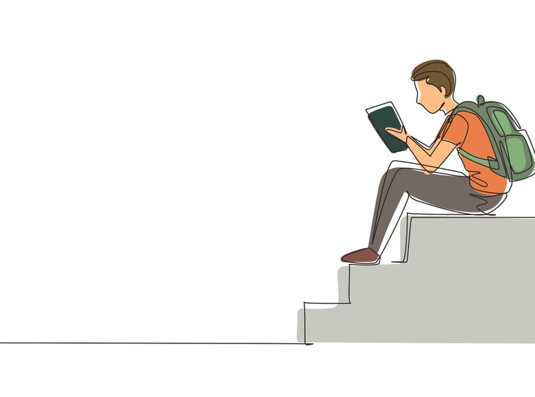 teenager reading book on steps