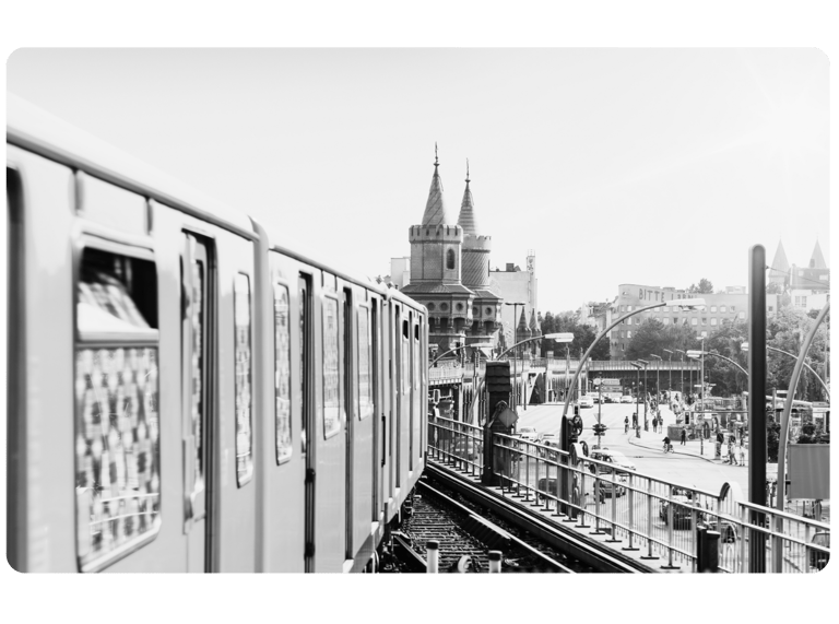 a train on a train track with a clock tower in the background
