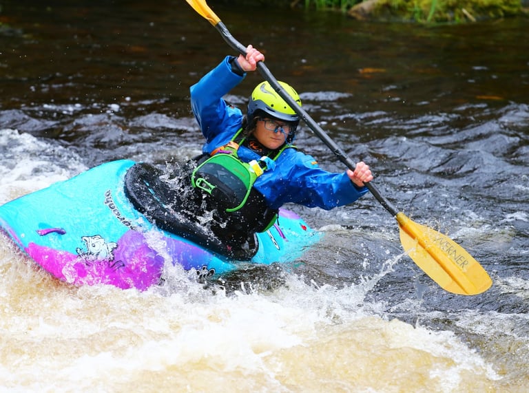 women in pyranha ozone in paddling down the upper Tryweryn 