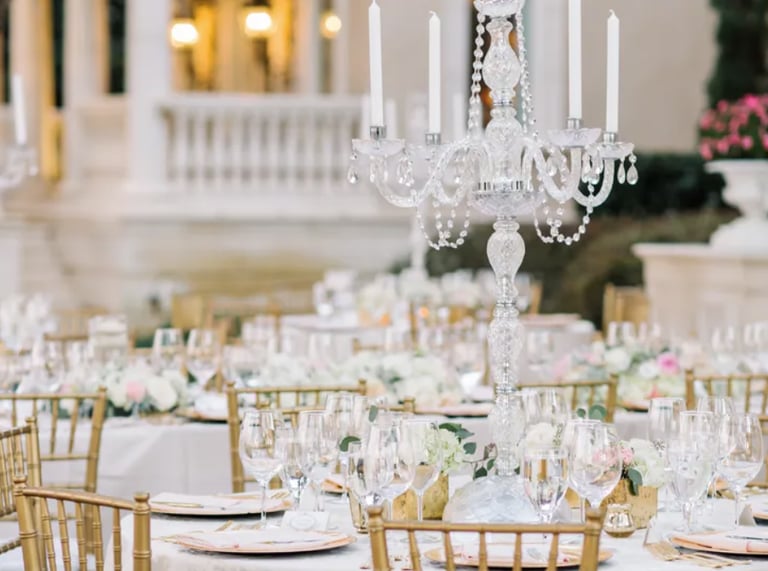 reception table with a chandelier and candles; event rentals