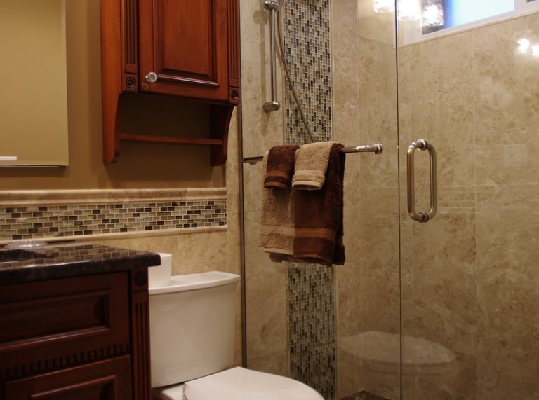 Bathroom remodeled with a glass walk-in shower, marble tiles in Arlington Heights