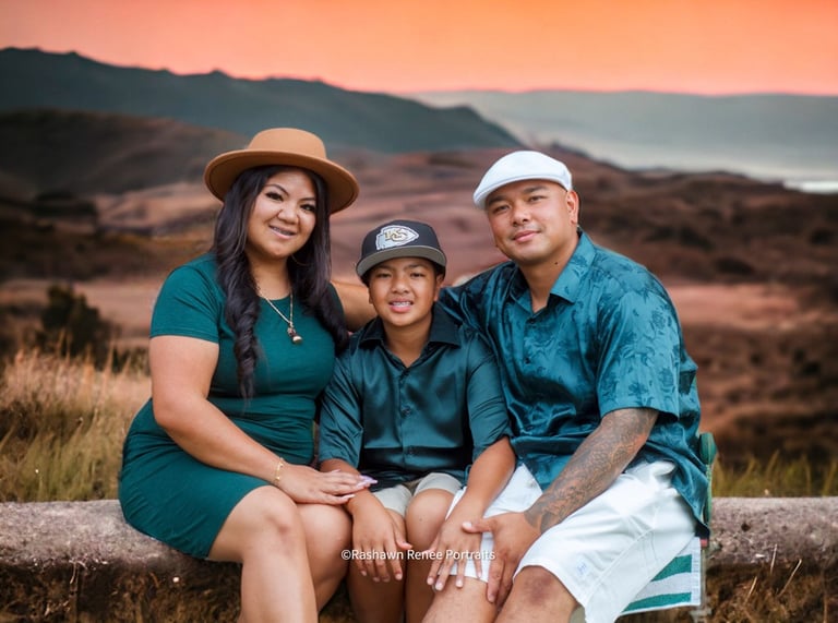 a family of three sitting on a bench in a field for a family Photoshoot
