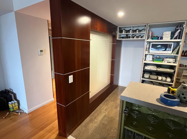 Modern white timber feature wall installation in residential kitchen