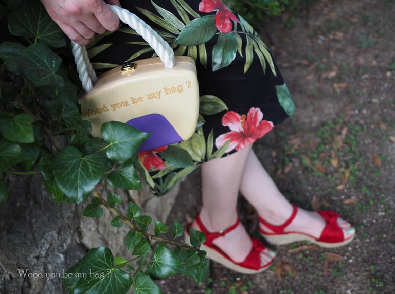 a woman in a dress with a wooden pin-up handbag