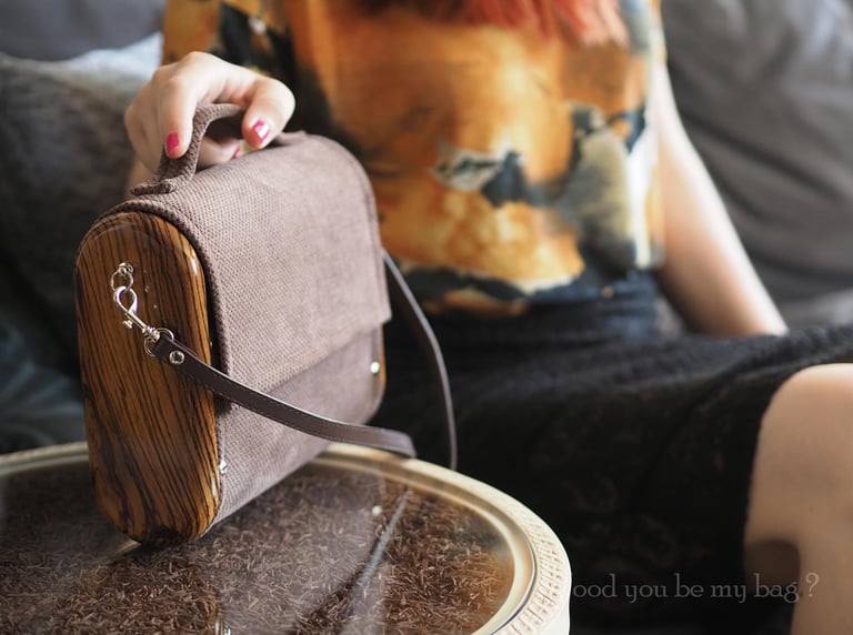 Woman holding wooden bag made from exotic zebrano wood