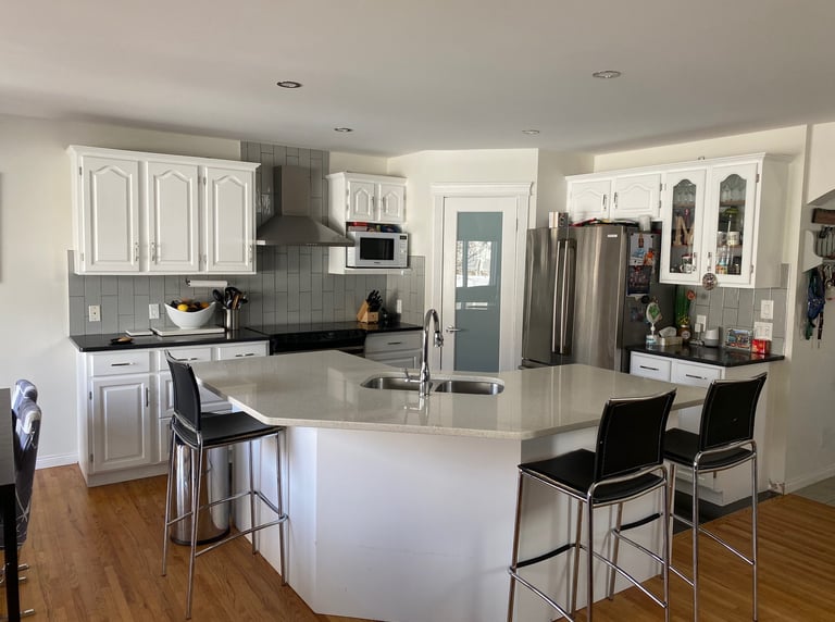 Oak cabinets mordenized with white coat of paint sprayed