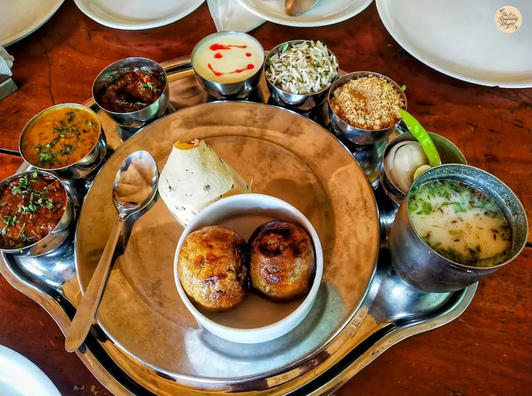Traditional Rajasthani thali with dal baati churma, gatte ki sabzi, and other dishes