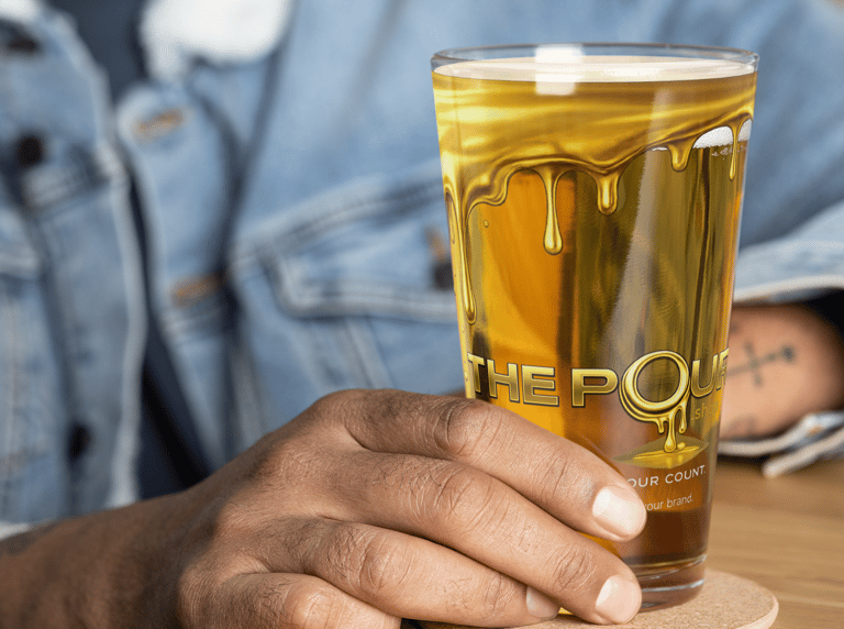 The Pour Shop branded pint glass shown in packaging box with materials demonstrating hospitality merchandise presentation