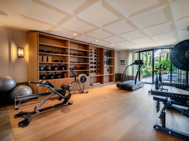 Private gym at Villa La Gratitud with modern equipment and garden views