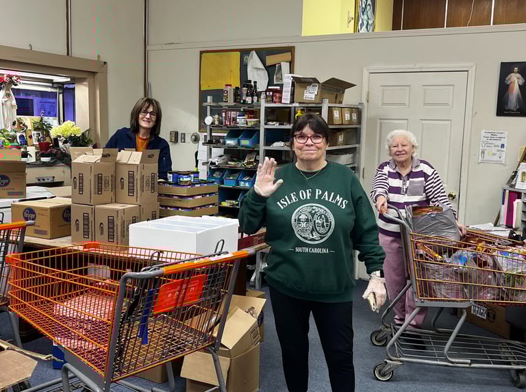 A group of happy volunteers working in the food pantry