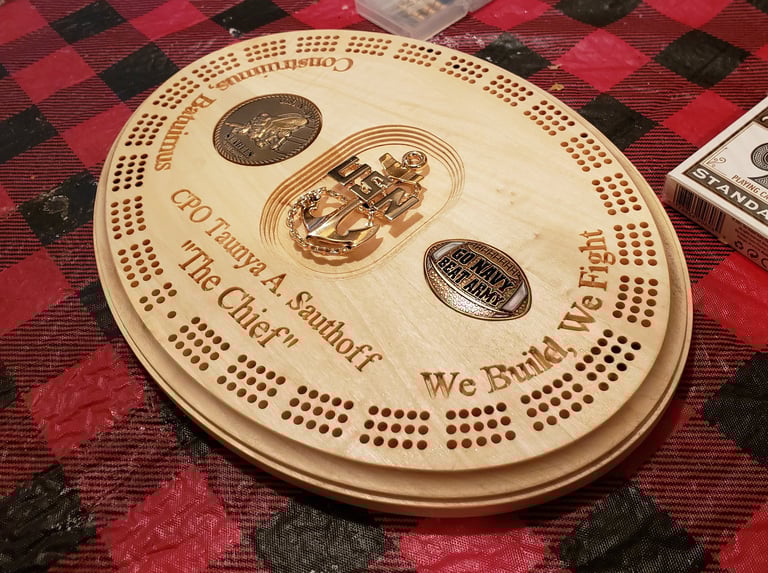 A custom gift for a retired Navy Seabee, a working cribbage board with inset coins.