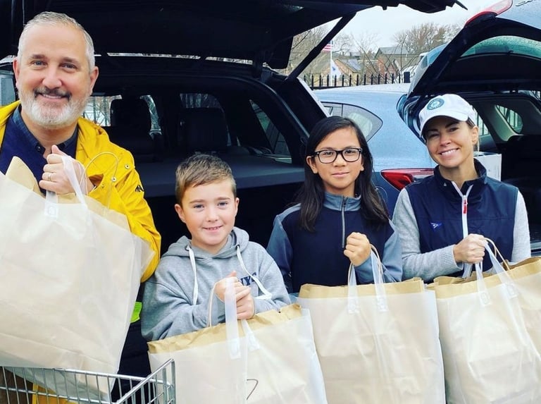 a group of people standing in front of a car