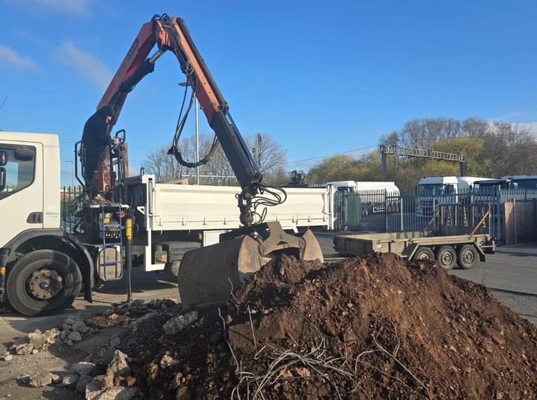 Commercial muck-away grab lorry operating on site within the West Midlands area