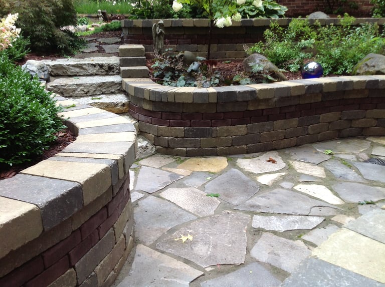 Leppek Landscapes designed and installed flagstone patio, ledge rock steps, and retaining walls.