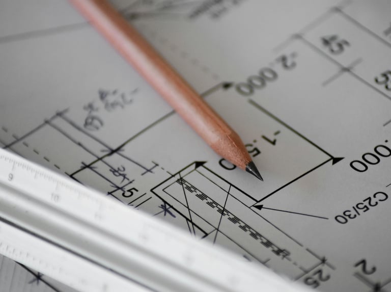 Architect reviewing building drawings during fire safety design development.