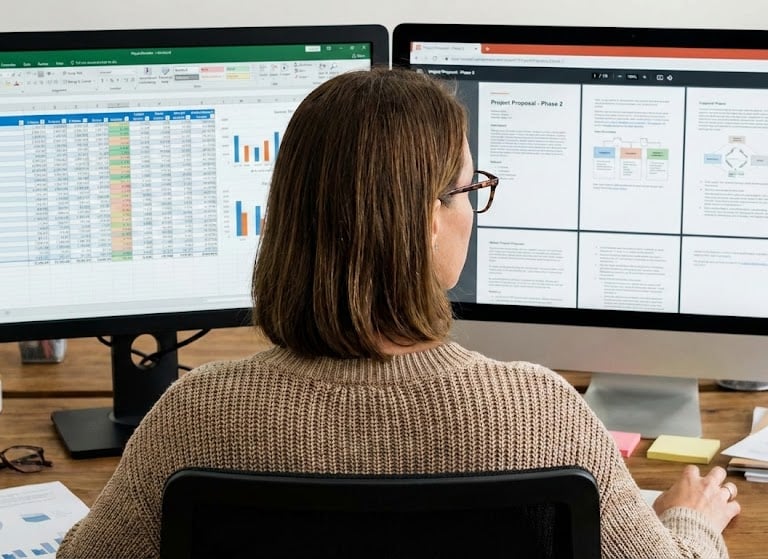 woman looking at computer screens