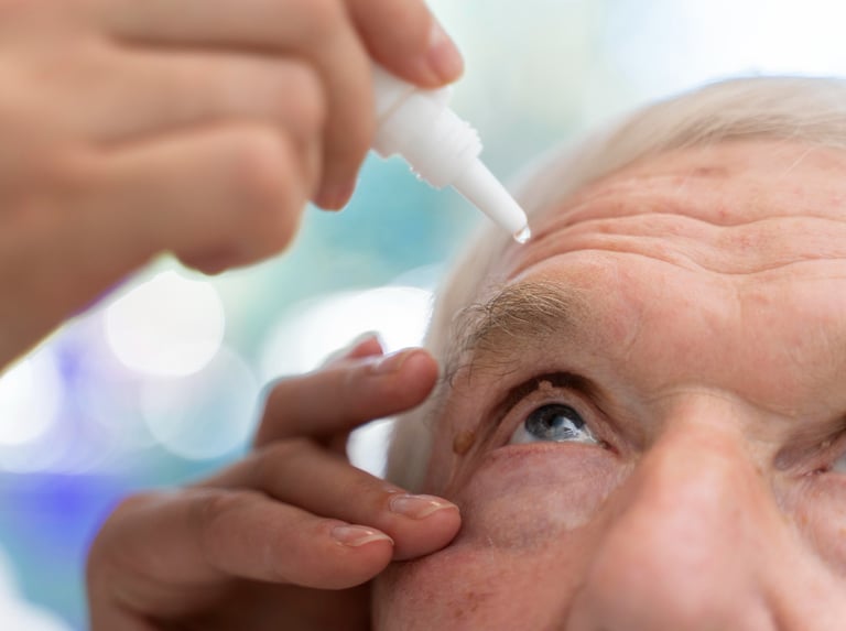 a man with a white eyeliners is getting his eyeliners