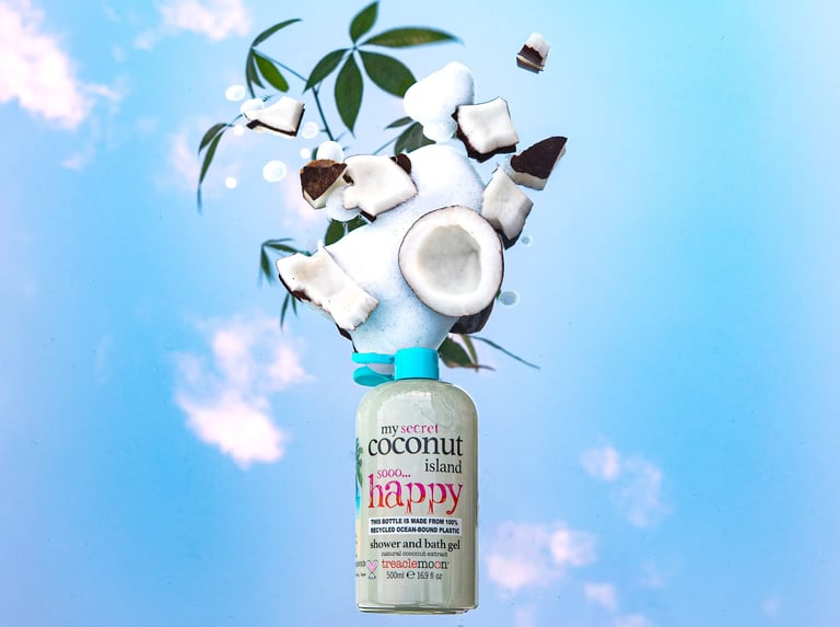 Treaclemoon Coconut Island shower gel with floating coconut pieces against a blue sky